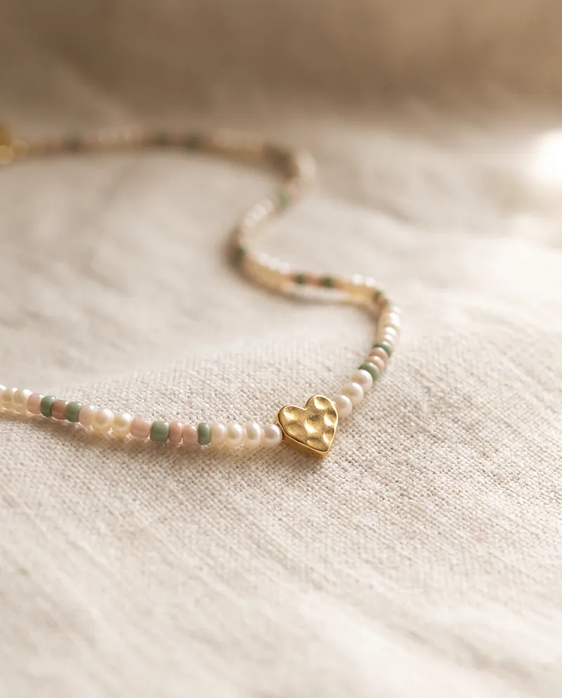 Dainty handmade pearl and seed-bead necklace with a small gold heart charm